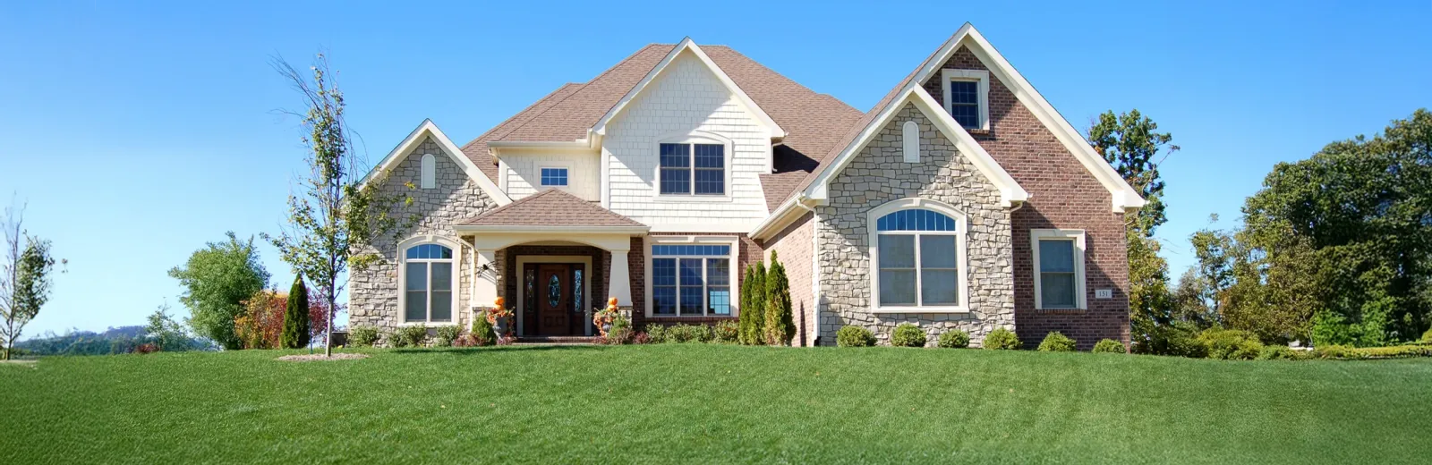 house with beautiful green front lawn